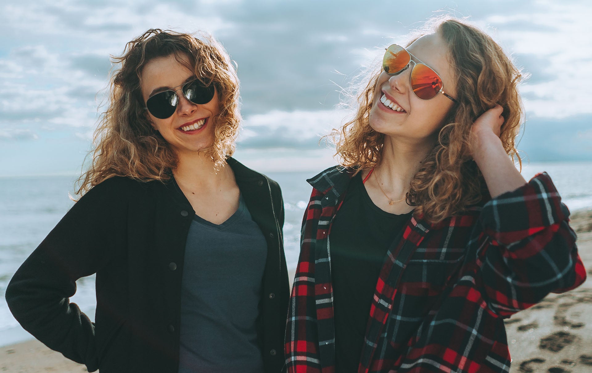 Malaga twins wearing premium titanium sunglasses.