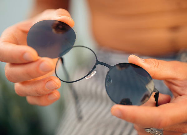 Round titanium sunglasses with changeable lenses.