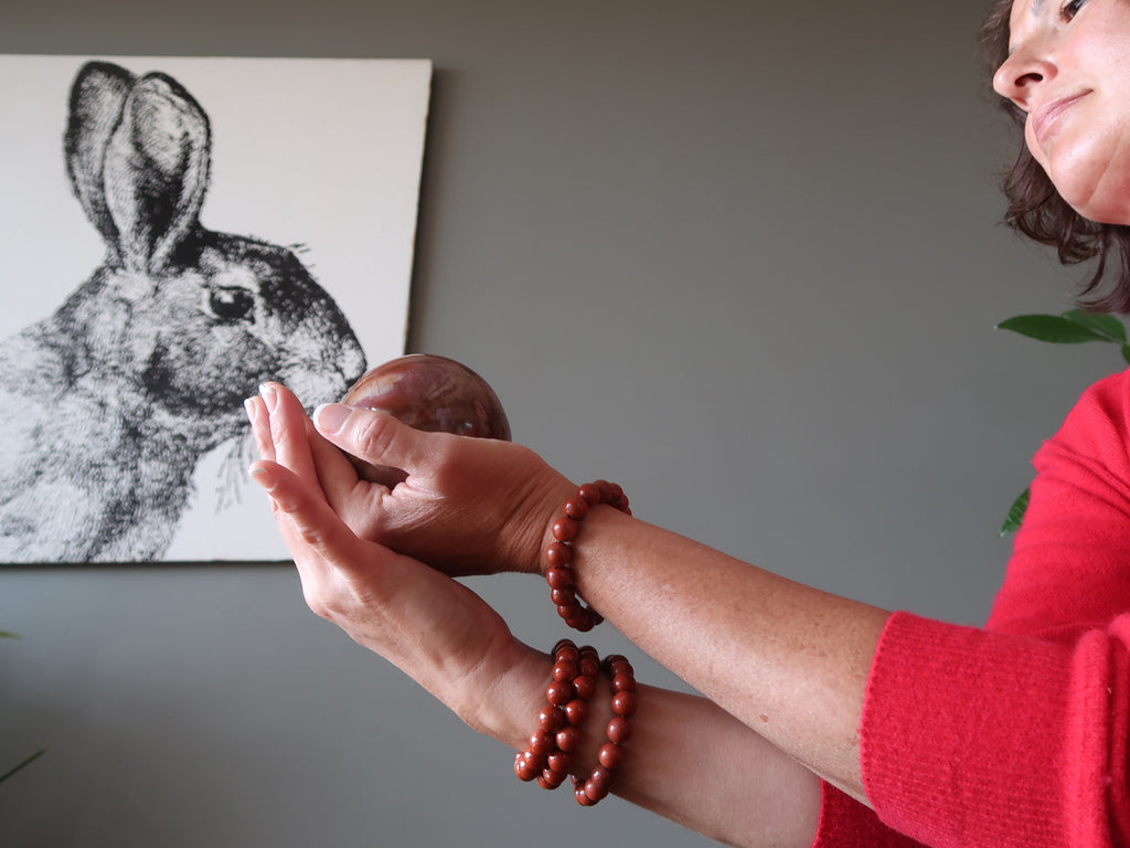 lady holding sphere in front of rabbit photo