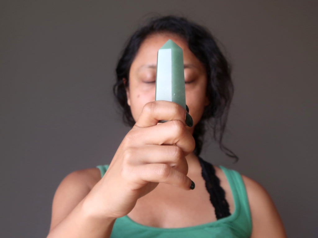 sheila of satin crystals meditating with a green aventurine tower wand stone