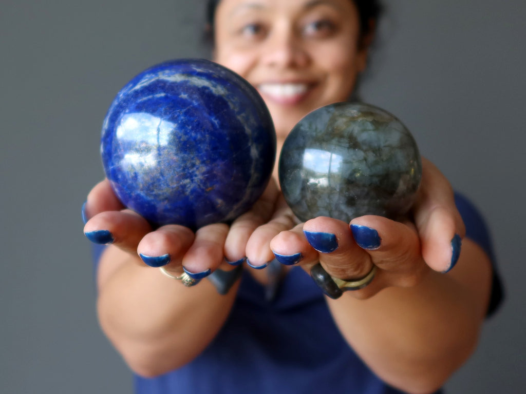 woman holding lapis and labradorite spheres