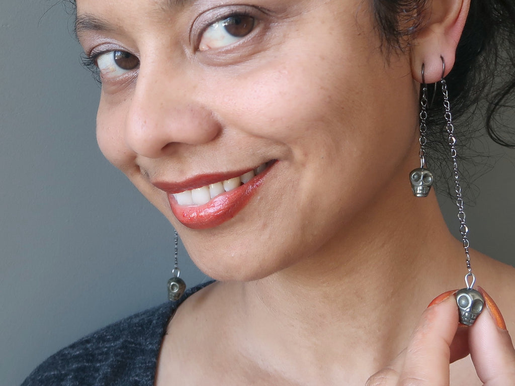 sheila of satin crystals wearing pyrite skull earrings