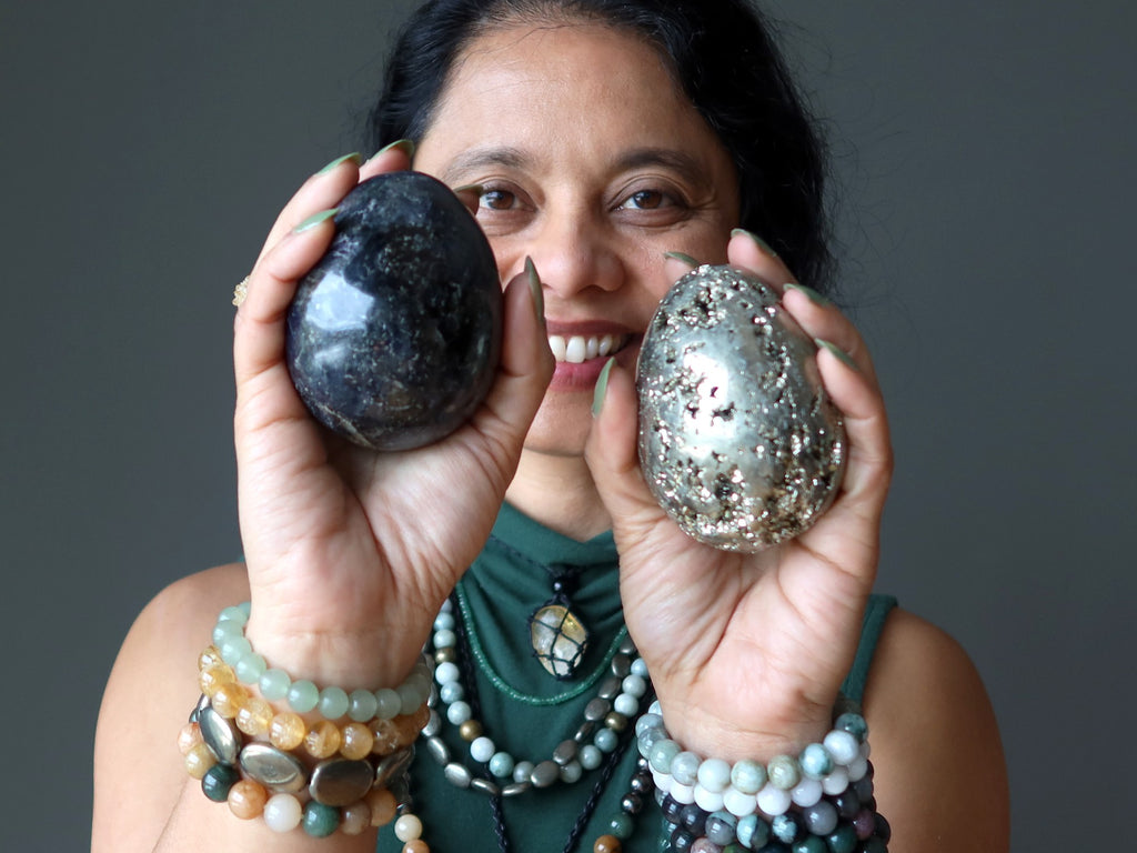 woman holding iolite and pyrite eggs