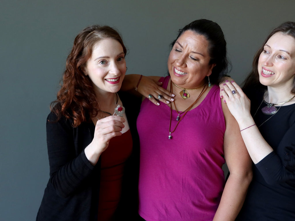 three ladies wearing ruby jewelry