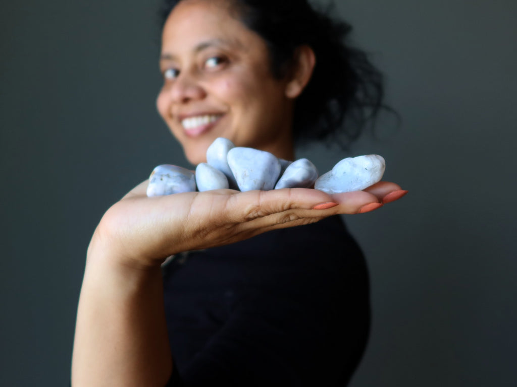 woman holding agate tumbled stones