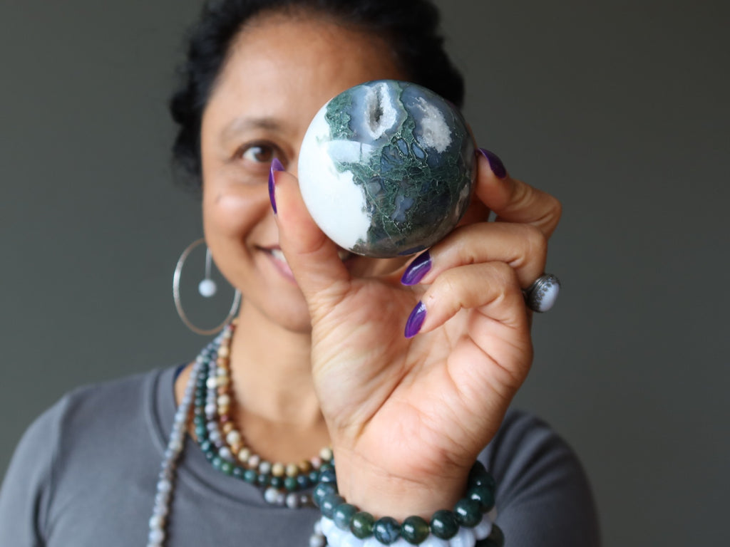 sheila of satin crystals holding moss agate sphere