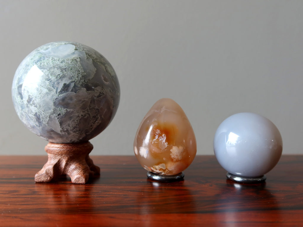 agate egg and spheres on stands