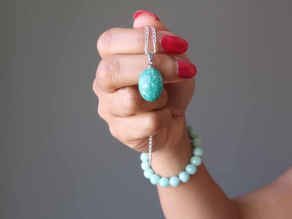 amazonite pendant on sterling silver chain and hand wearing amazonite stretch bracelet - satin crystals