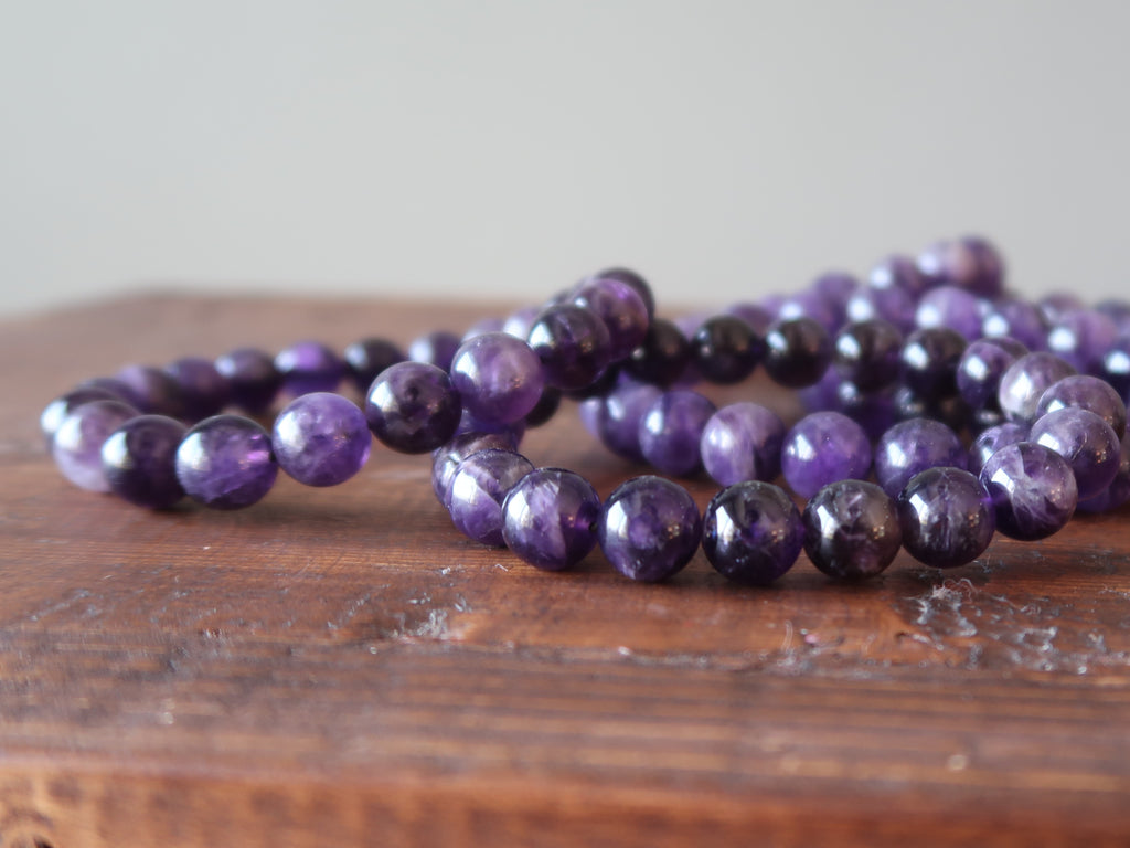 Pile of dark purple Amethyst bracelets