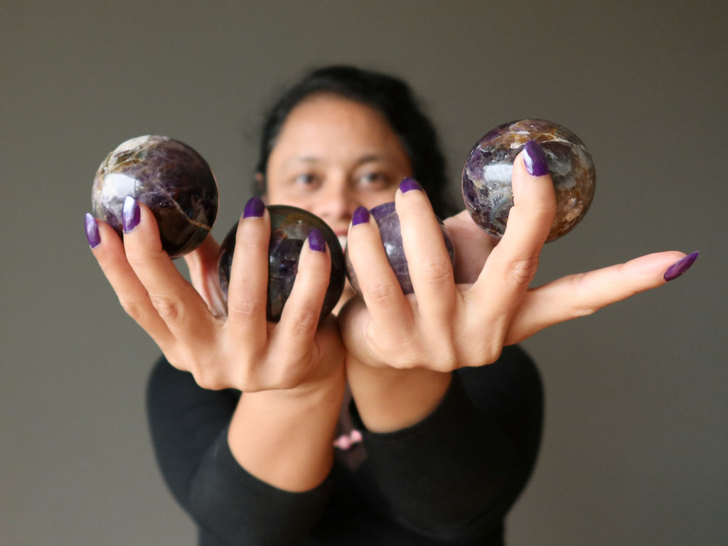 sheila of satin crystals holding 4 amethyst spheres