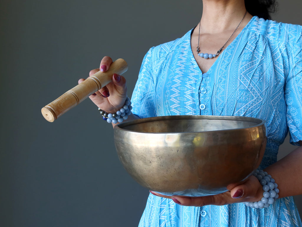 female playing tibetan singing bowl