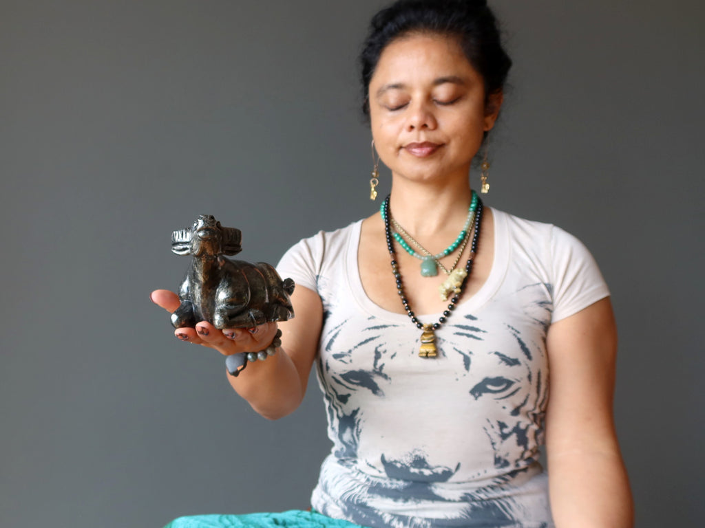 woman meditating with pyrite bull