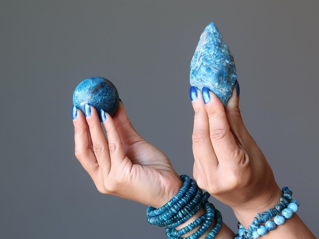 hands wearing apatite bracelets holding apatite stones