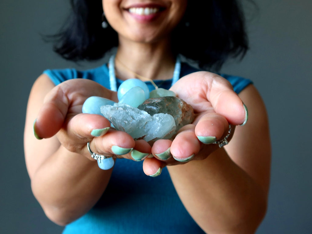 aquamarine stones in hands