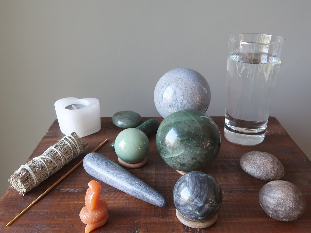 aventurine crystals, moqui marbles, water, candle, sage, incense to prepare for meditation