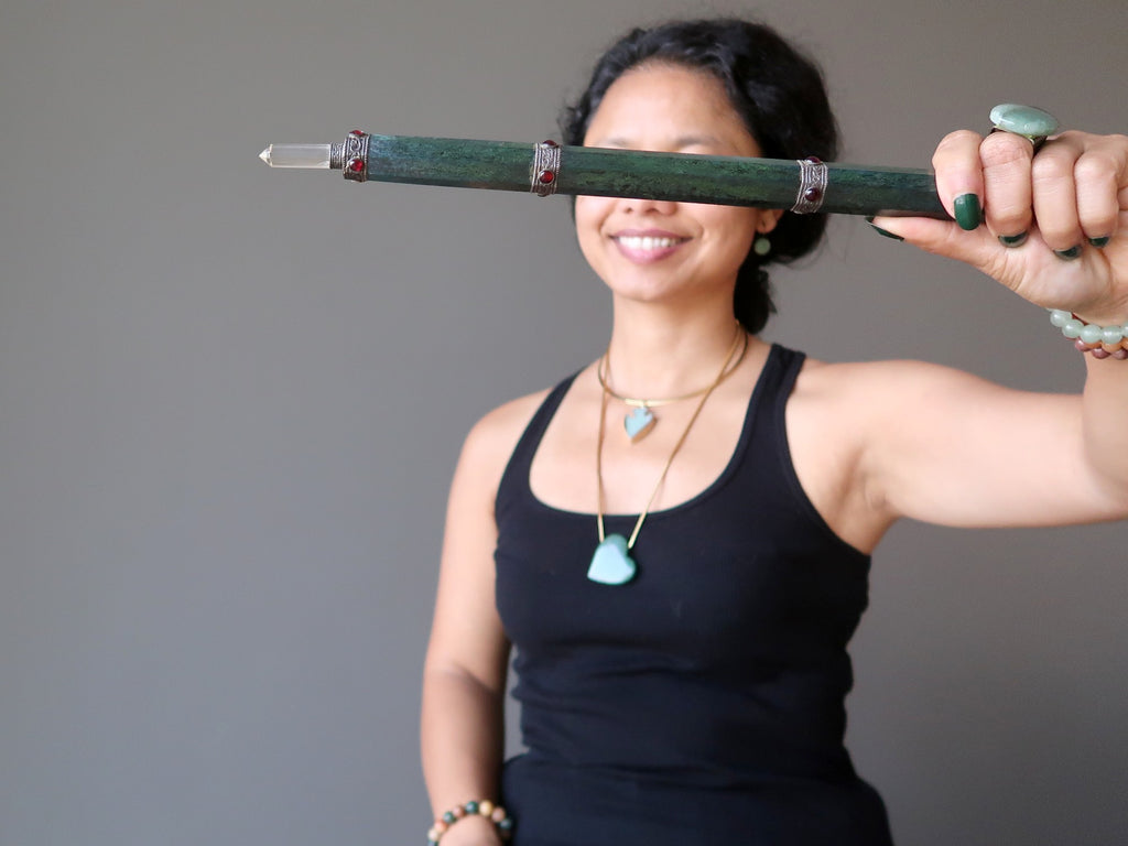 sheila of satin crystals holding a long green aventurine wand