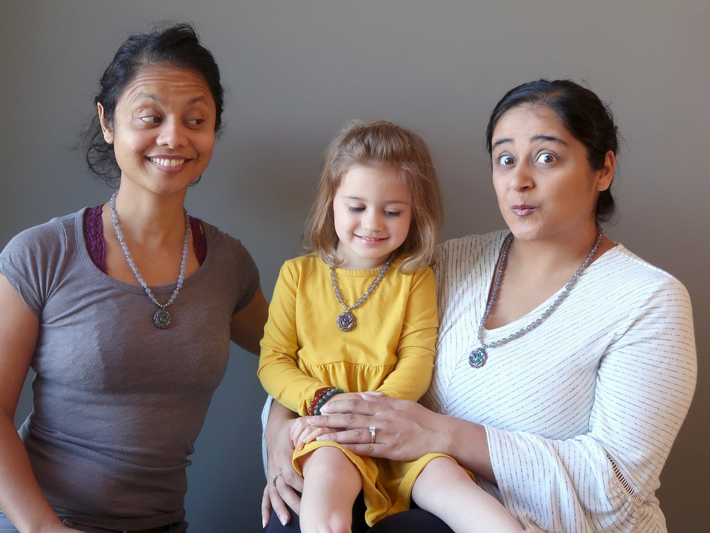 two sisters and niece wearing matching crystal healing necklaces