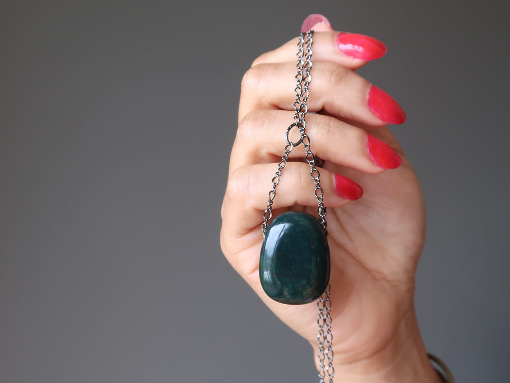 hand holding a bloodstone gunmetal chain necklace