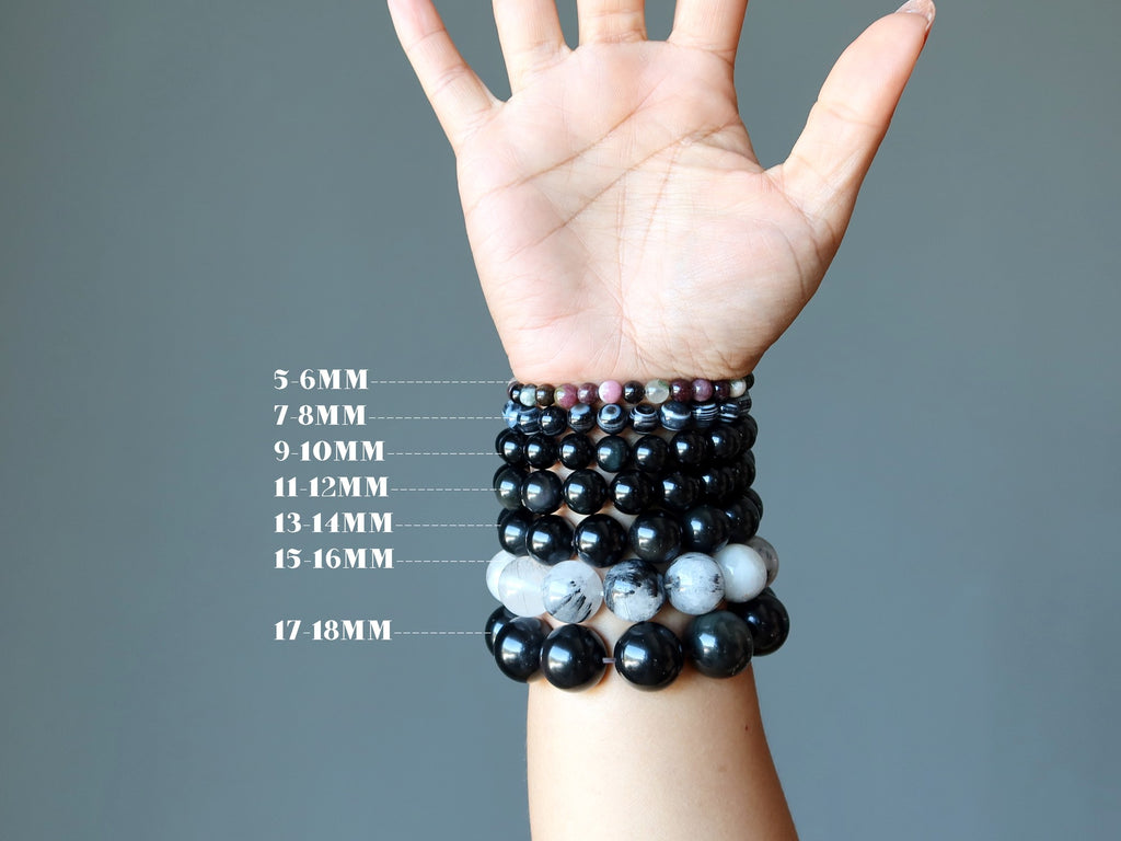 hand wearing bracelets in all bead sizes