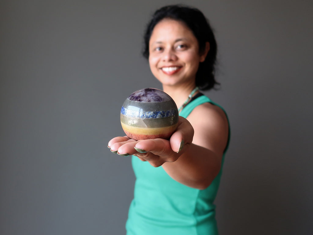 sheila of satin crystals holding out a 7 layered chakra crystal ball