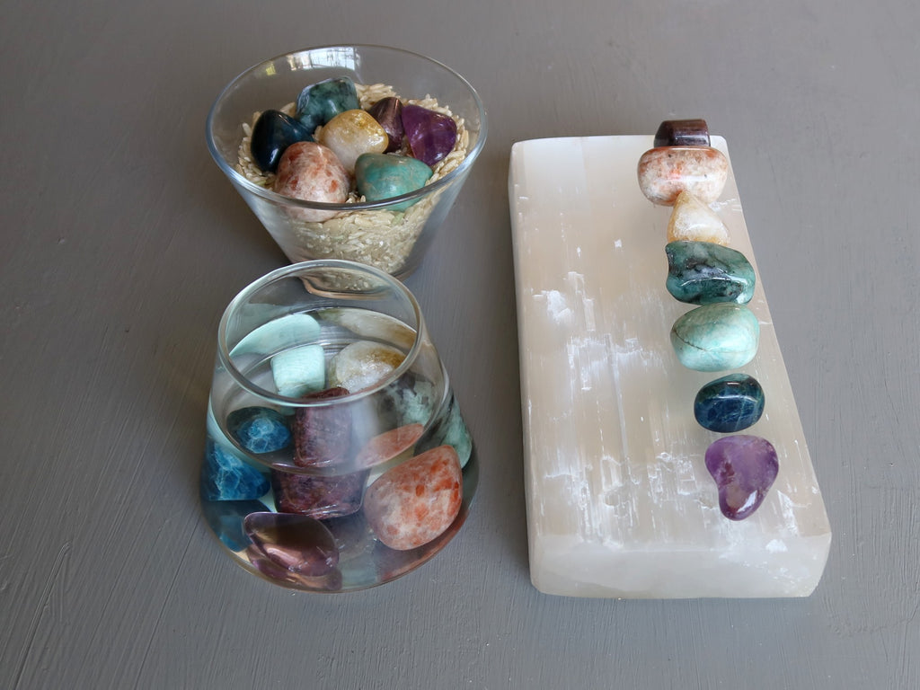 chakra stones on selenite, in water and in brown rice