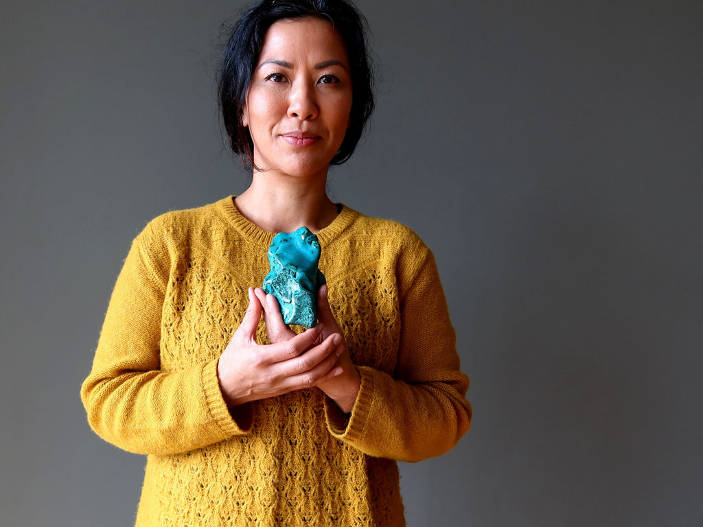 lady holding chrysocolla rough