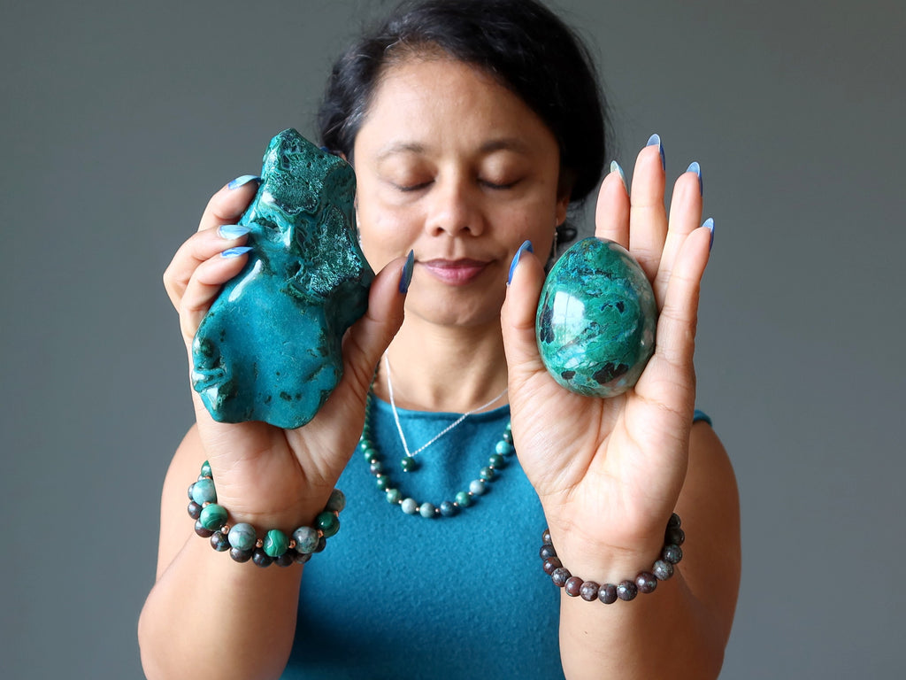 woman holding chrysocolla stones