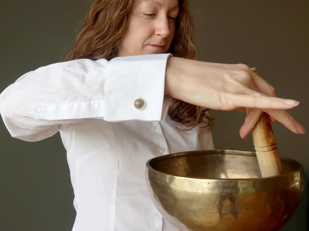 jamie of satin crystals playing a tibetan singing bowl wearing unakite cufflinks