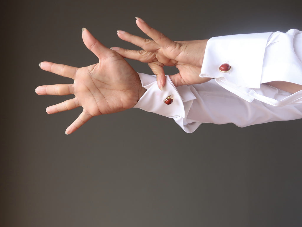 outstretched french cuff arms with red jasper cufflinks