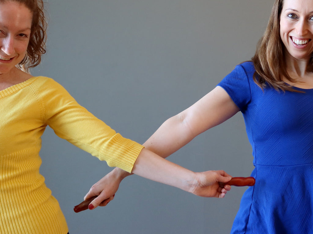 two girls using carnelian wands to cut the energy cord