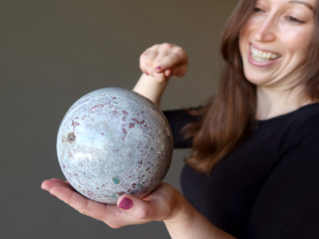 woman holding jasper sphere pointing