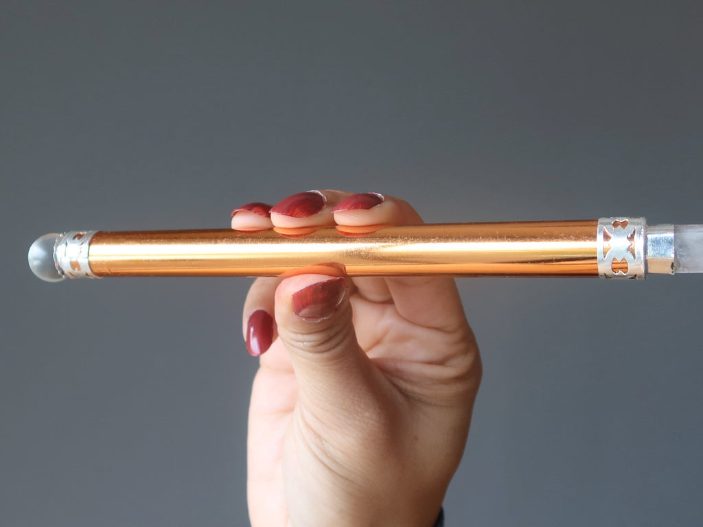 hand holding copper wand