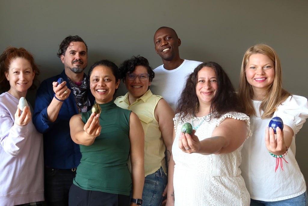 group of people holding crystals eggs