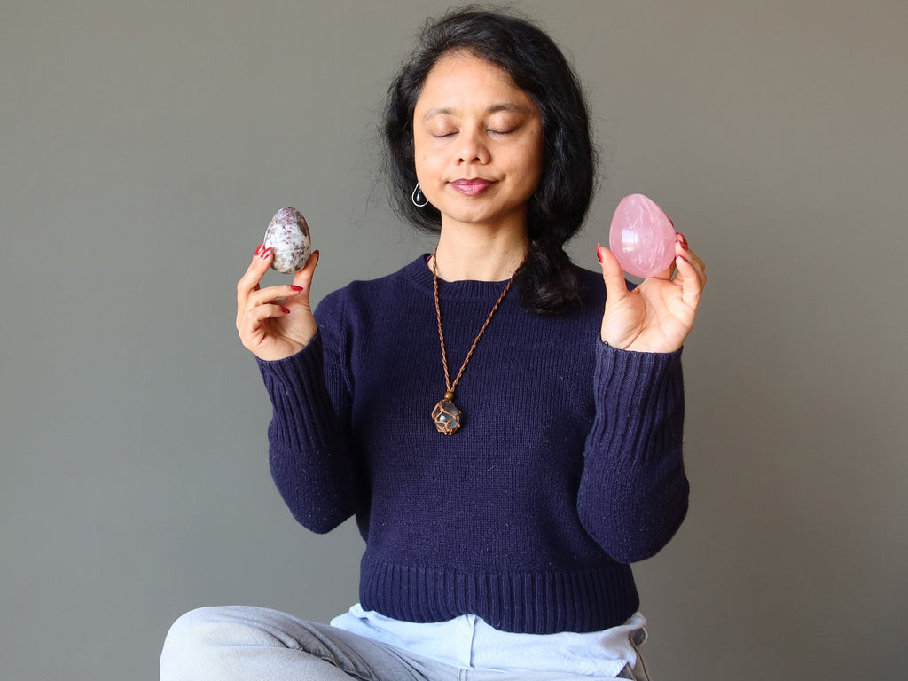 woman meditatiing with crystal eggs