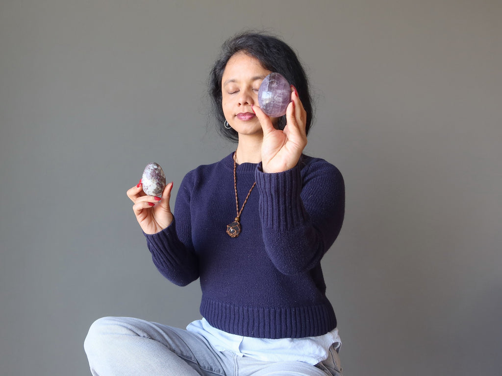 woman meditating with crystal eggs