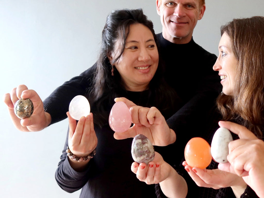 people holding crystals eggs