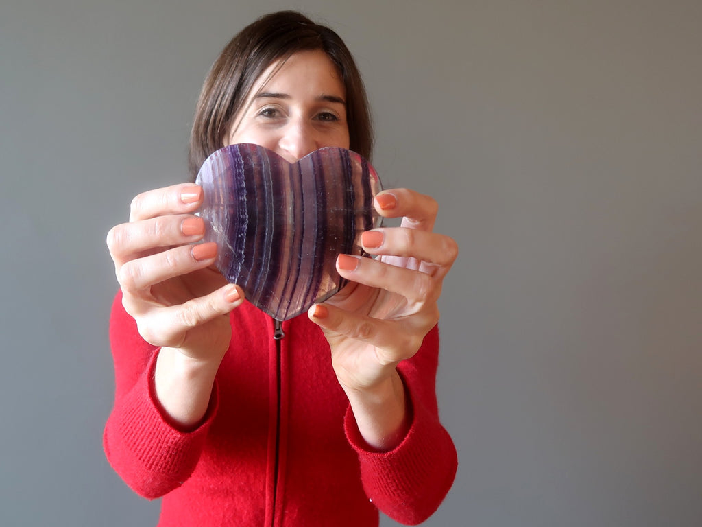 woman holding purple fluorite heart