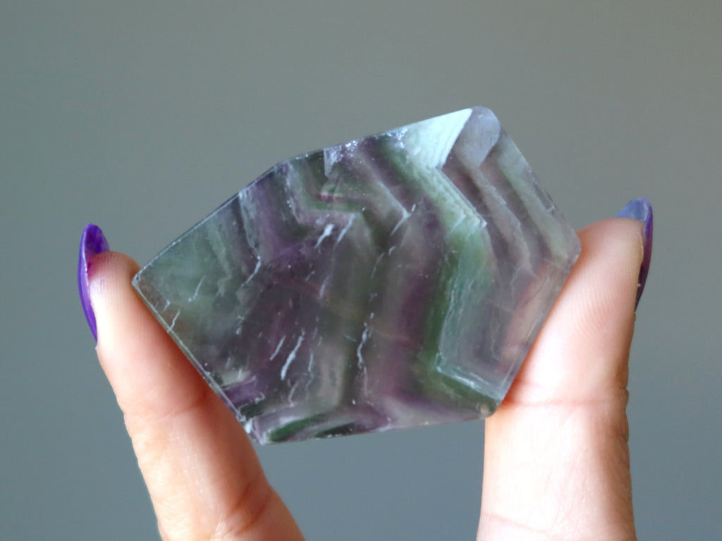 hand holding fluorite slab