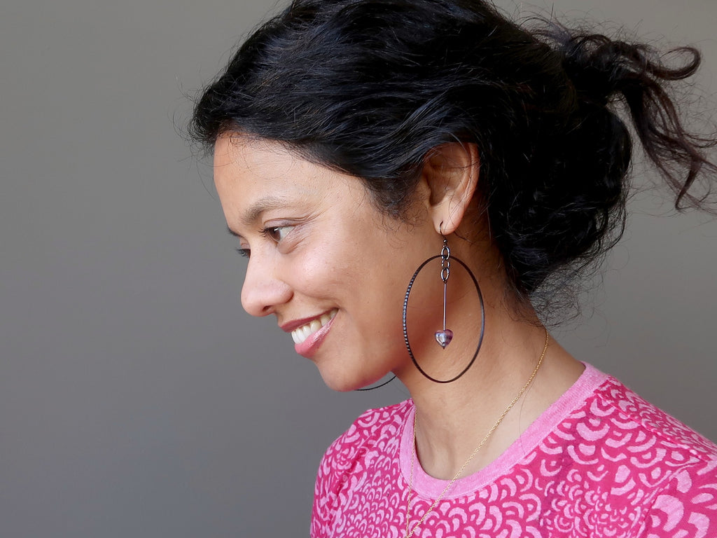 sheila of satin crystals wearing purple fluorite heart black large hoop earrings