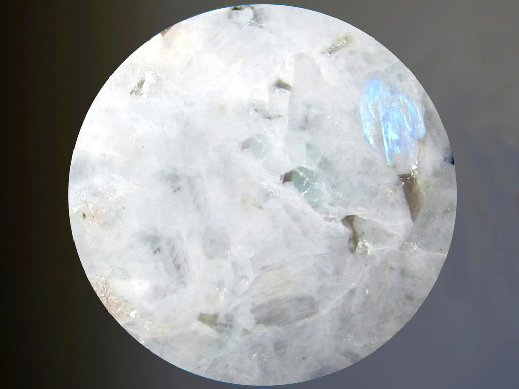 white rainbow moonstone sphere against gray background