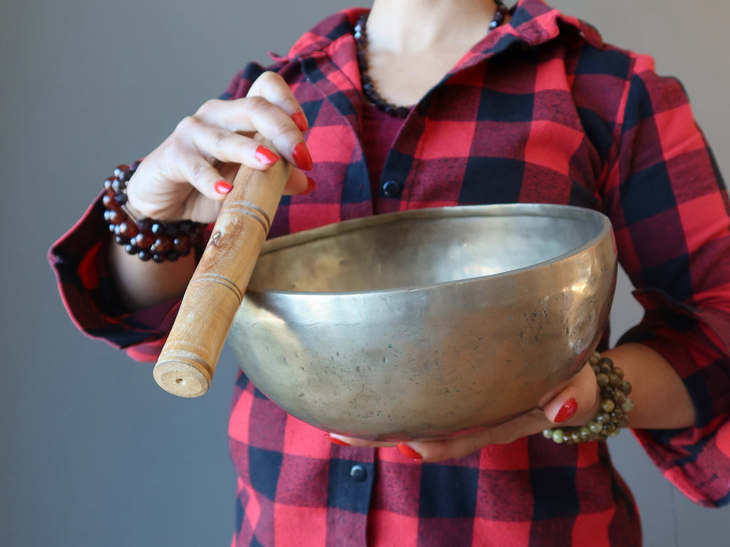 woman playing tibetan singing bowl