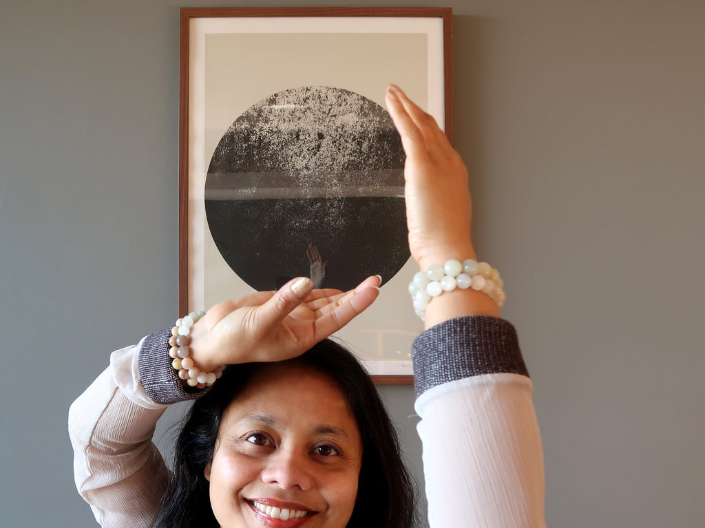 sheila of satin crystals wearing moonstone in front of a moon picture for harvest supermoon