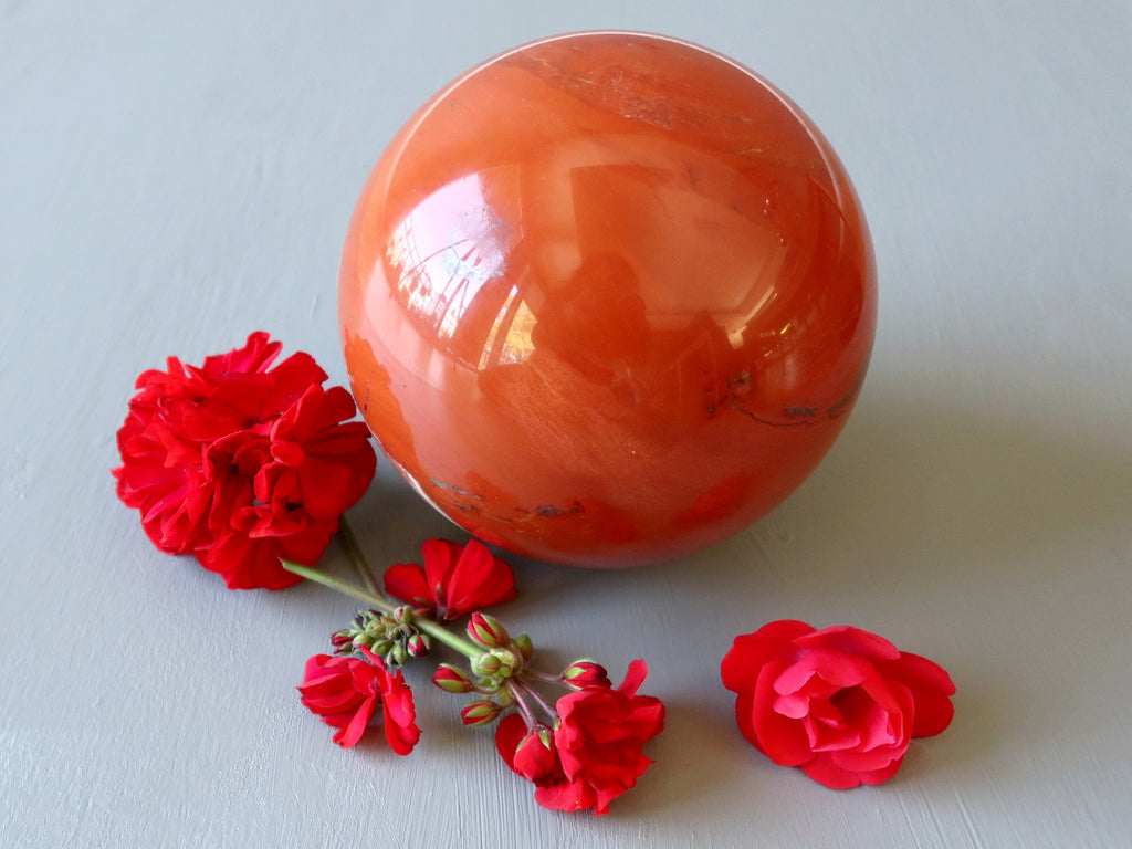 japer ball surrounded by red flowers