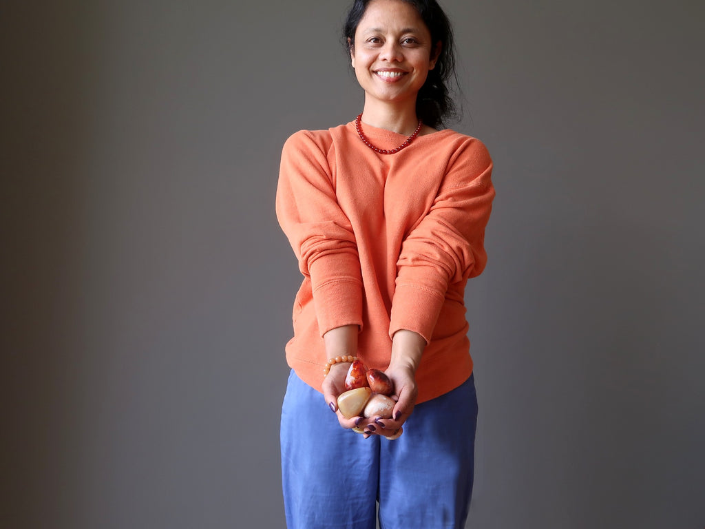 sheila of satin crystals holding carnelian at her sacral chakra