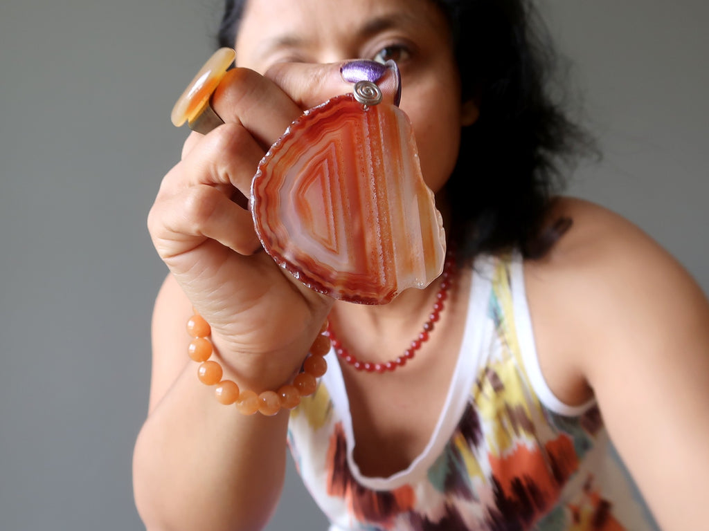 sheila of satin crystals holding a large carnelian slab