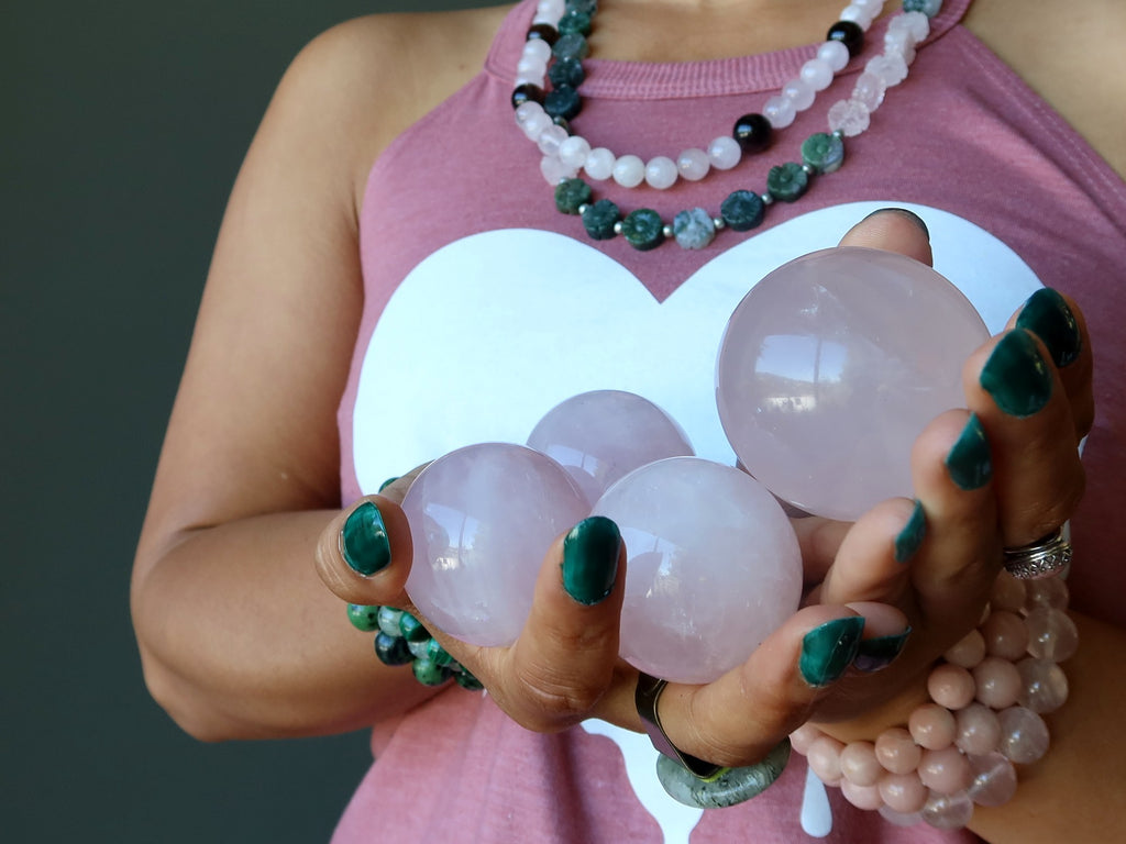 sheila of satin crystals holding 4 rose quartz spheres