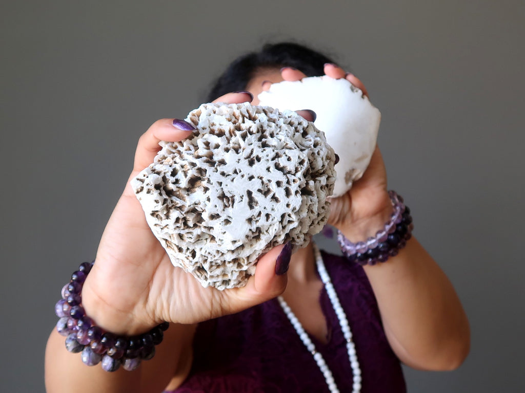 sheila of satin crystals holding up two white scolecite domes