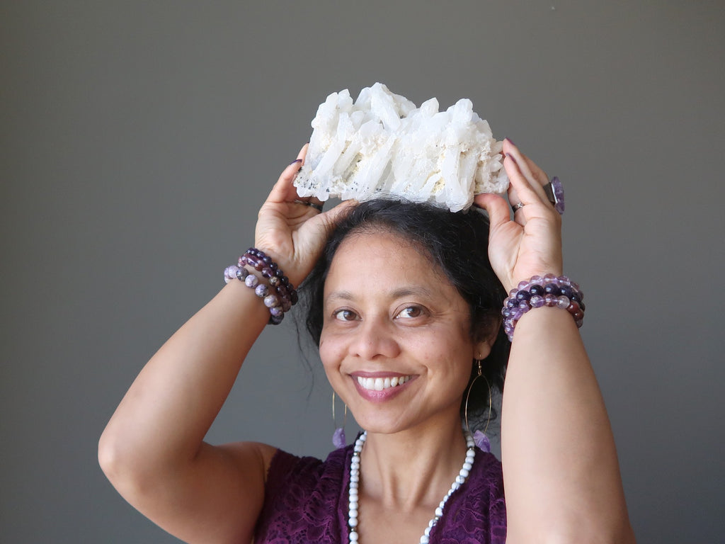 sheila of satin crystals with a white quartz cluster at her crown chakra