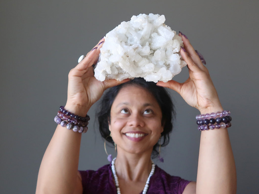 sheila of satin crystals with a quartz cluster at her crown chakra