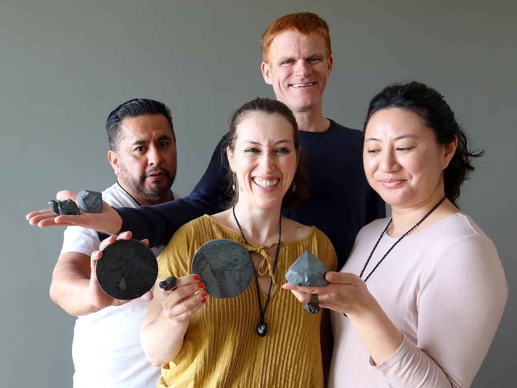 people holding hematite crystals